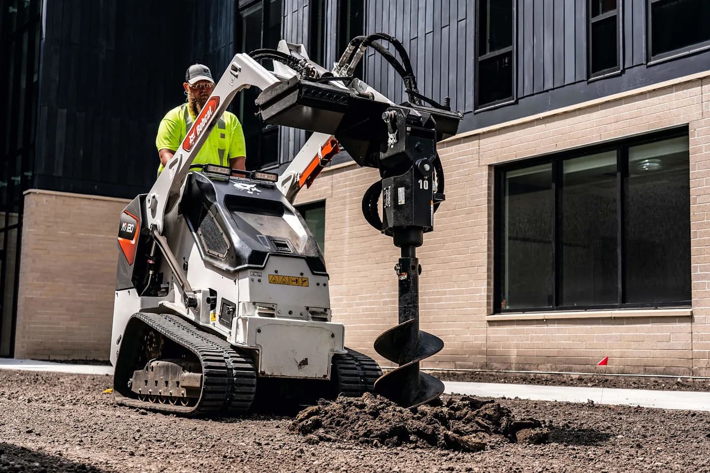 Bobcat MT-120 mini skid steer running an auger attachment to drill footing holes